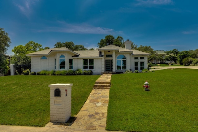 101 Peterson Ct, Austin, TX 78734 - view of front of home with a chimney, a front yard, a metal roof, and brick siding