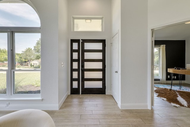 101 Peterson Ct, Austin, TX 78734 - entrance foyer featuring light wood-style flooring, baseboards, and arched walkways