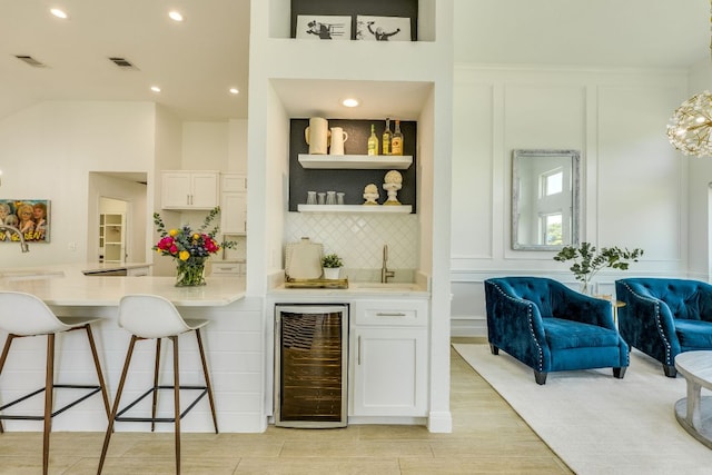 101 Peterson Ct, Austin, TX 78734 - indoor wet bar featuring wine cooler, a decorative wall, decorative backsplash, light wood-type flooring, and recessed lighting