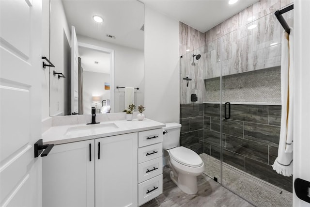 204 Love Creek Ct, Spicewood, TX 78669 - bathroom featuring vanity, a shower stall, toilet, and recessed lighting