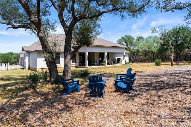 204 Love Creek Ct, Spicewood, TX 78669 - rear view of house featuring stucco siding, a patio area, a fire pit, and a shingled roof