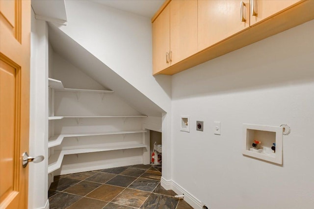 4715 Highland Ter, Austin, TX 78731 - laundry area with cabinet space, hookup for an electric dryer, dark stone finish flooring, and hookup for a washing machine