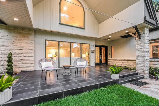 4715 Highland Ter, Austin, TX 78731 - rear view of property featuring stone siding, french doors, and a patio