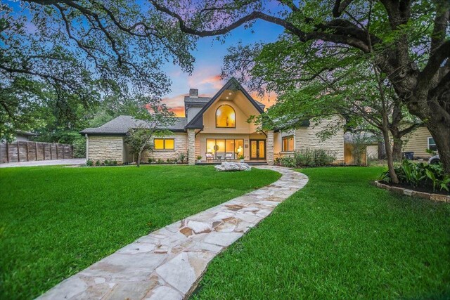4715 Highland Ter, Austin, TX 78731 - view of front facade featuring stone siding, a chimney, and stucco siding