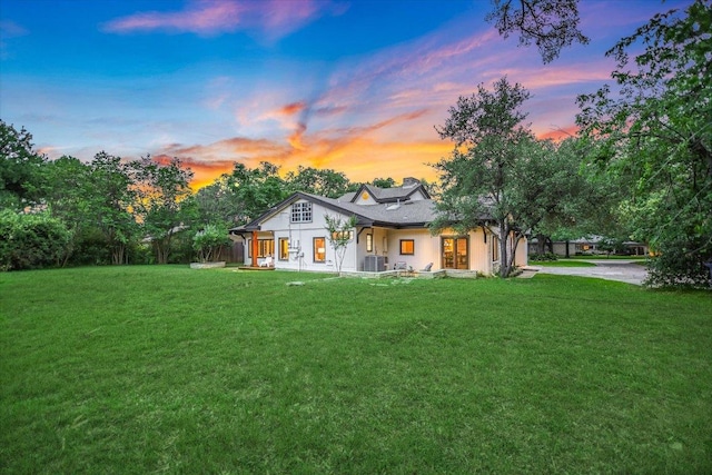 4715 Highland Ter, Austin, TX 78731 - back of house at dusk with a yard and covered porch