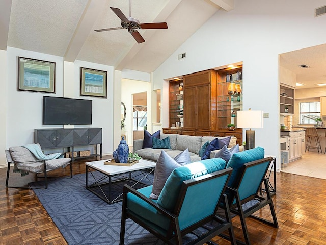 1400 Pearl Cv, Round Rock, TX 78681 - living room featuring a ceiling fan, beam ceiling, high vaulted ceiling, and a textured ceiling
