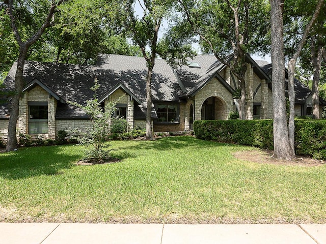 1400 Pearl Cv, Round Rock, TX 78681 - view of front of property with stone siding, a front lawn, and roof with shingles