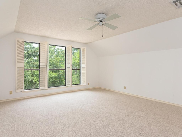 1400 Pearl Cv, Round Rock, TX 78681 - additional living space with vaulted ceiling, light colored carpet, a ceiling fan, and a textured ceiling