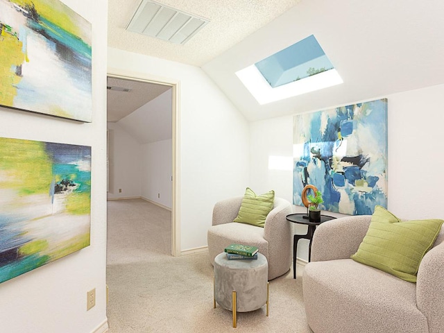 1400 Pearl Cv, Round Rock, TX 78681 - sitting room featuring a skylight, carpet floors, and vaulted ceiling