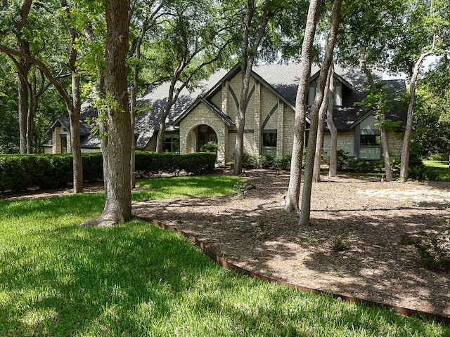 1400 Pearl Cv, Round Rock, TX 78681 - tudor home featuring a front yard and a shingled roof