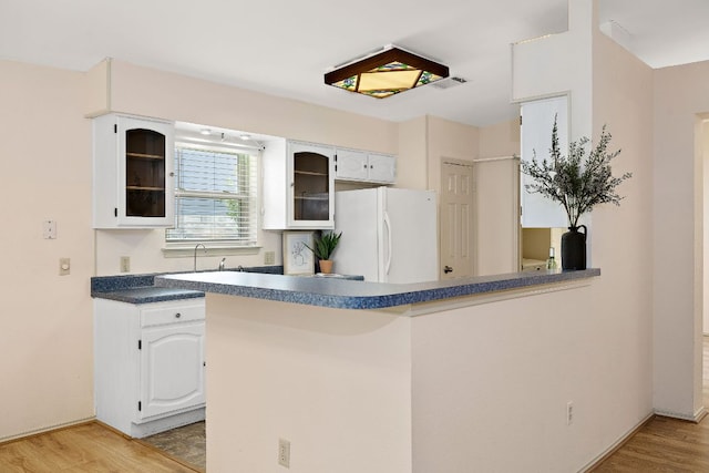 8507 Tad Park Cv, Round Rock, TX 78681 - kitchen with freestanding refrigerator, glass insert cabinets, white cabinets, and light wood-style floors