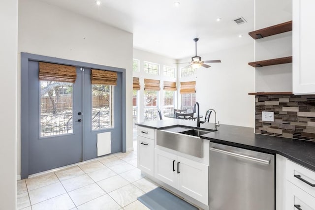 10 Lakewood Cir, Wimberley, TX 78676 - kitchen featuring dishwasher, a sink, open shelves, backsplash, and dark countertops