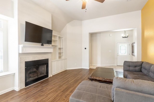 10 Lakewood Cir, Wimberley, TX 78676 - living area with a tile fireplace, a ceiling fan, wood finished floors, baseboards, and vaulted ceiling