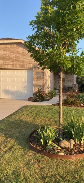 401 Yorktown St, Georgetown, TX 78633 - view of front facade featuring a front lawn, an attached garage, driveway, and brick siding