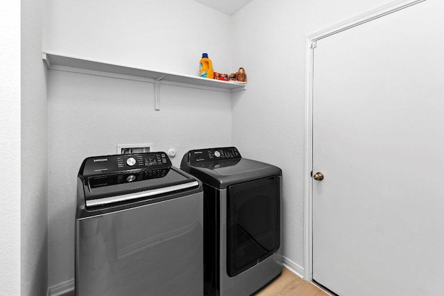 114 Ashford Way, Georgetown, TX 78626 - washroom featuring washing machine and dryer, light wood-type flooring, and baseboards