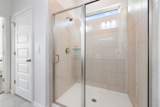 13002 Stanford Dr Unit 40, Austin, TX 78748 - bathroom featuring a shower stall, tile patterned flooring, and baseboards