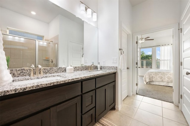 13002 Stanford Dr Unit 40, Austin, TX 78748 - ensuite bathroom featuring double vanity, tile patterned floors, a shower stall, and a ceiling fan