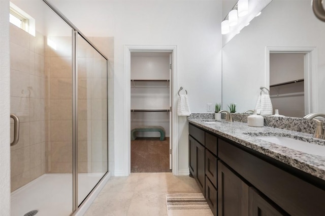 13002 Stanford Dr Unit 40, Austin, TX 78748 - full bathroom with a spacious closet, double vanity, a shower stall, and tile patterned flooring