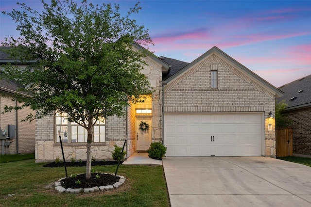 13002 Stanford Dr Unit 40, Austin, TX 78748 - view of front of property featuring stone siding, a garage, driveway, and a front lawn
