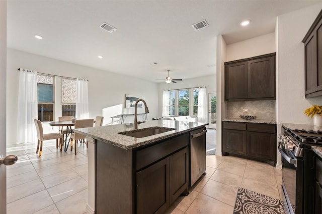 13002 Stanford Dr Unit 40, Austin, TX 78748 - kitchen featuring a sink, appliances with stainless steel finishes, dark brown cabinets, a ceiling fan, and backsplash