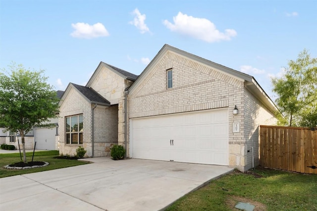 13002 Stanford Dr Unit 40, Austin, TX 78748 - view of front of house with brick siding, concrete driveway, stone siding, and a garage