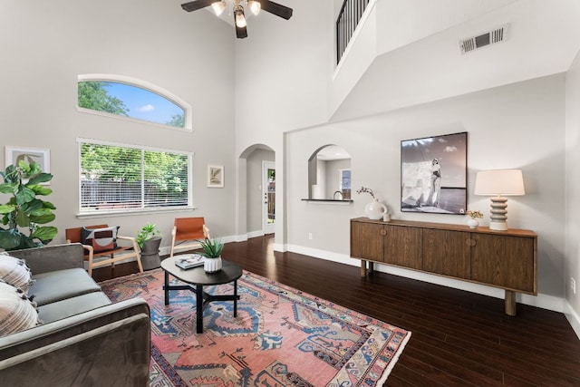 2500 Wilma Rudolph Rd, Austin, TX 78748 - living area featuring ceiling fan, wood-type flooring, baseboards, arched walkways, and a towering ceiling