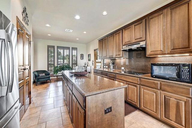 21012 N Rdg, Lago Vista, TX 78645 - kitchen featuring black appliances, under cabinet range hood, a center island, dark stone counters, and decorative backsplash