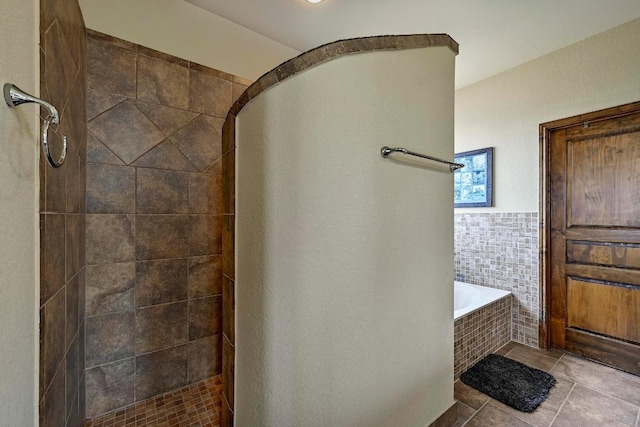 21012 N Rdg, Lago Vista, TX 78645 - full bathroom featuring tile patterned floors, a garden tub, a tile shower, and tile walls