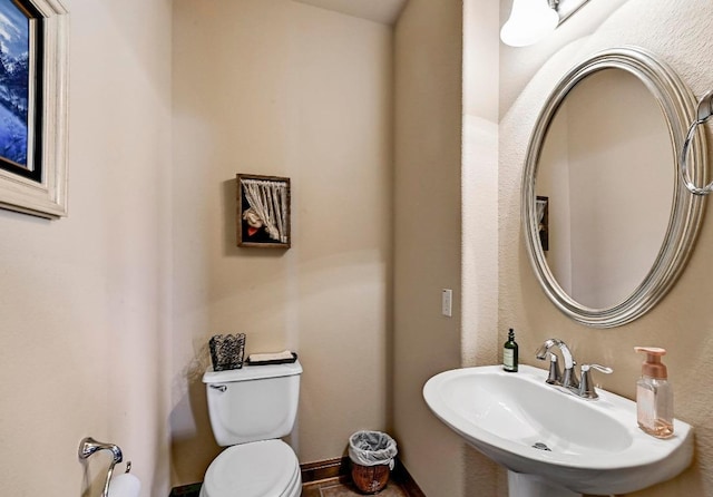 21012 N Rdg, Lago Vista, TX 78645 - half bathroom with a sink, toilet, and baseboards