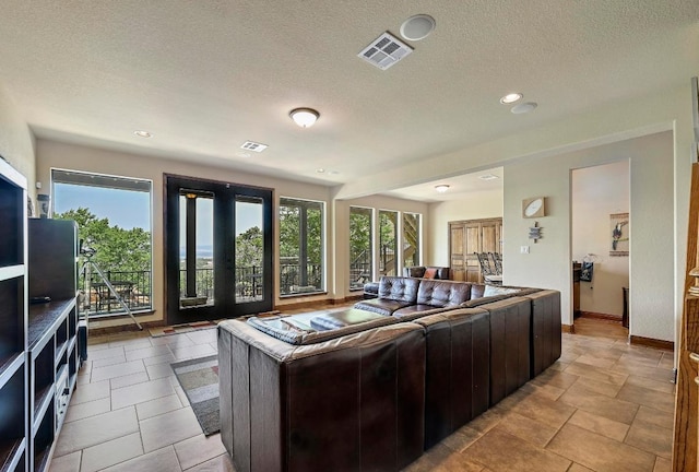 21012 N Rdg, Lago Vista, TX 78645 - living area with plenty of natural light, a textured ceiling, french doors, baseboards, and recessed lighting