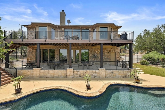21012 N Rdg, Lago Vista, TX 78645 - back of property featuring stairs, a patio, a wooden deck, brick siding, and a chimney