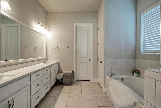 20304 Thumper Jack Ct, Pflugerville, TX 78660 - bathroom with double vanity, a bath, and tile patterned floors