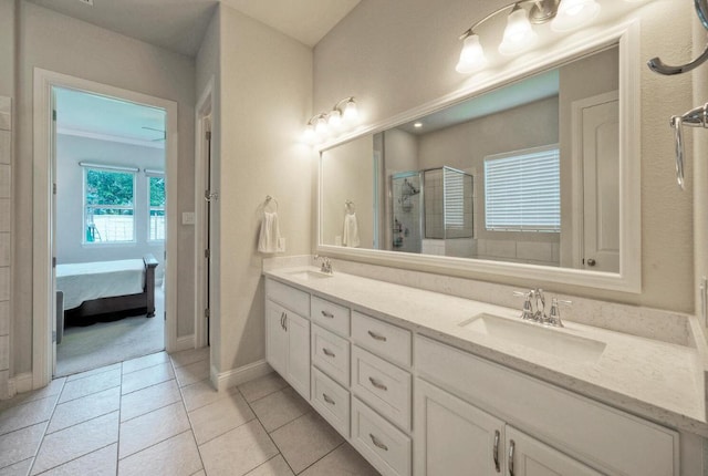 20304 Thumper Jack Ct, Pflugerville, TX 78660 - bathroom featuring ensuite bathroom, double vanity, a stall shower, tile patterned flooring, and baseboards