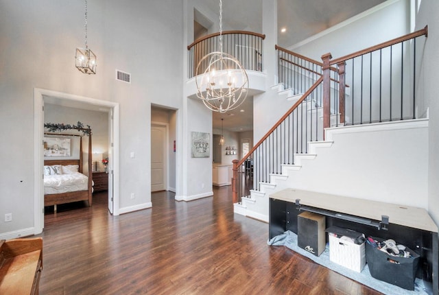20304 Thumper Jack Ct, Pflugerville, TX 78660 - foyer entrance with a chandelier, stairway, a towering ceiling, and wood finished floors