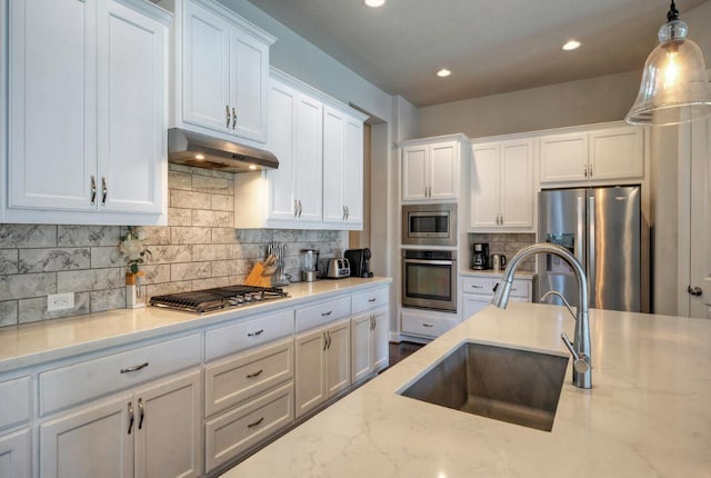 20304 Thumper Jack Ct, Pflugerville, TX 78660 - kitchen with appliances with stainless steel finishes, a sink, white cabinets, backsplash, and recessed lighting