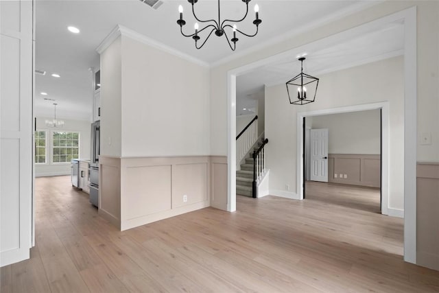 206 High Plains Dr, Dripping Springs, TX 78620 - unfurnished dining area featuring a chandelier, stairway, a decorative wall, crown molding, and light wood-style flooring