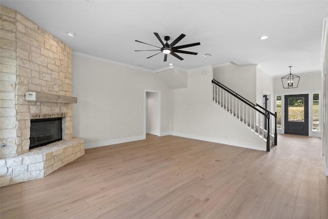 206 High Plains Dr, Dripping Springs, TX 78620 - unfurnished living room with stairs, light wood-style floors, ornamental molding, a fireplace, and baseboards