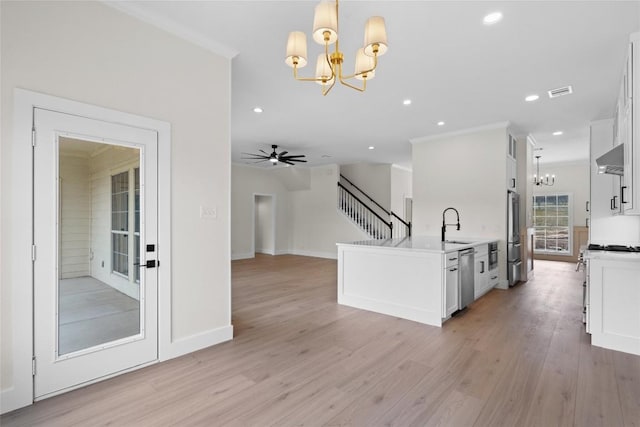 206 High Plains Dr, Dripping Springs, TX 78620 - kitchen with a chandelier, stainless steel appliances, white cabinets, light wood-type flooring, and recessed lighting