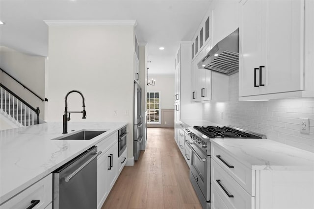 206 High Plains Dr, Dripping Springs, TX 78620 - kitchen featuring stainless steel appliances, extractor fan, a sink, recessed lighting, and light stone countertops