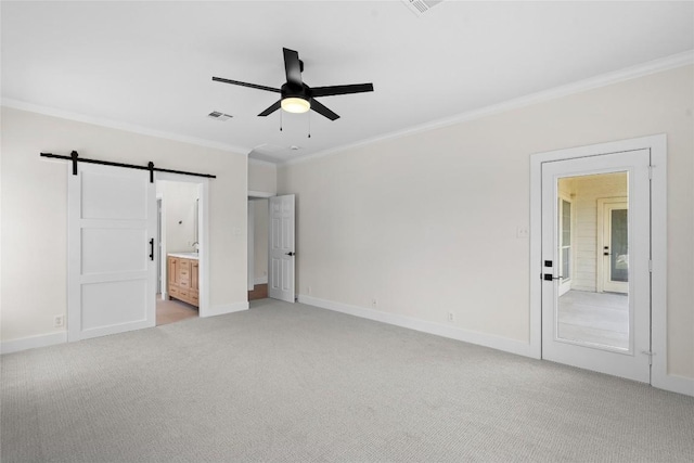 206 High Plains Dr, Dripping Springs, TX 78620 - unfurnished bedroom with a barn door, crown molding, light colored carpet, baseboards, and connected bathroom