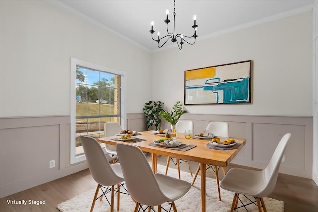 206 High Plains Dr, Dripping Springs, TX 78620 - dining area with a chandelier, a decorative wall, crown molding, wood finished floors, and wainscoting