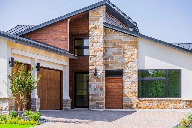 125 Azalea Loop, Horseshoe Bay, TX 78657 - property entrance with stone siding, an attached garage, and stucco siding