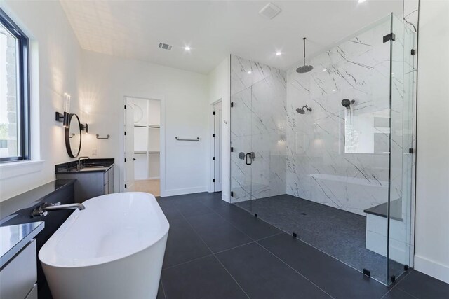 125 Azalea Loop, Horseshoe Bay, TX 78657 - full bath with a marble finish shower, a freestanding bath, vanity, a walk in closet, and recessed lighting