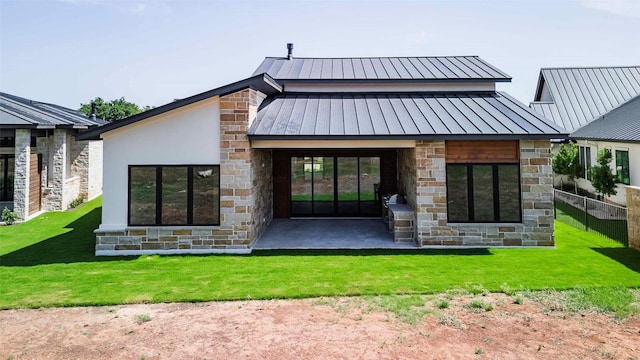 125 Azalea Loop, Horseshoe Bay, TX 78657 - back of property featuring a standing seam roof, stone siding, metal roof, and a patio area