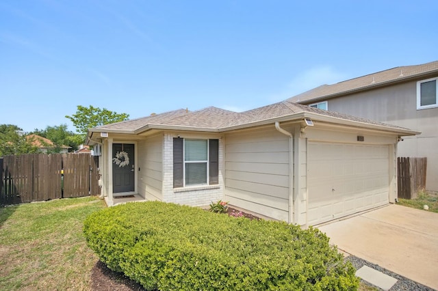 16708 Hamilton Point Cir, Manor, TX 78653 - view of front of home featuring an attached garage, driveway, brick siding, and a shingled roof