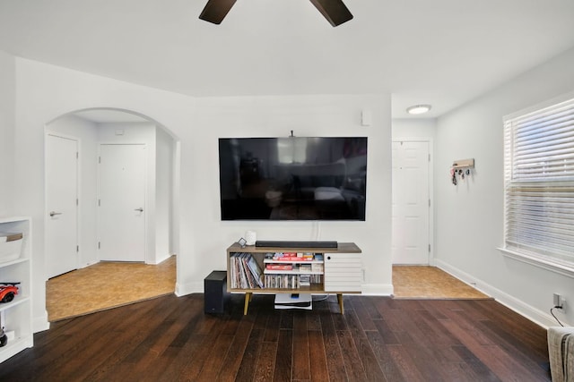 16708 Hamilton Point Cir, Manor, TX 78653 - living room with wood finished floors, a ceiling fan, arched walkways, and baseboards