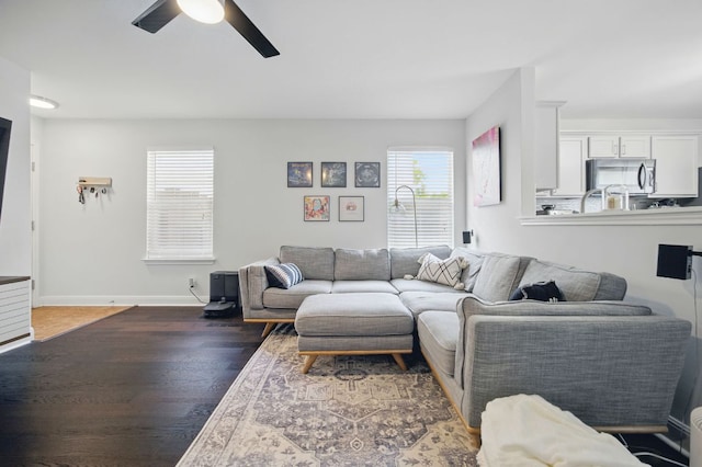 16708 Hamilton Point Cir, Manor, TX 78653 - living room with a ceiling fan, healthy amount of natural light, wood finished floors, and baseboards