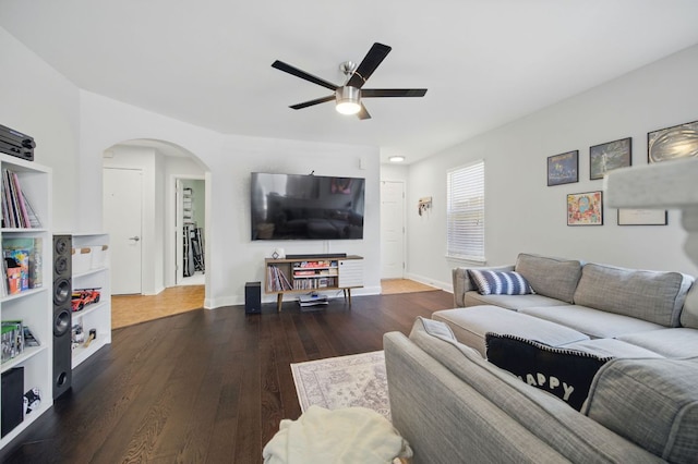 16708 Hamilton Point Cir, Manor, TX 78653 - living area with ceiling fan, arched walkways, wood finished floors, and baseboards