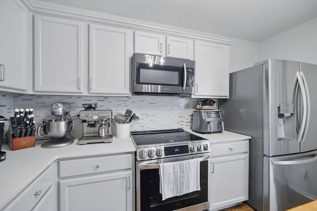 16708 Hamilton Point Cir, Manor, TX 78653 - kitchen with appliances with stainless steel finishes, backsplash, light countertops, and white cabinets