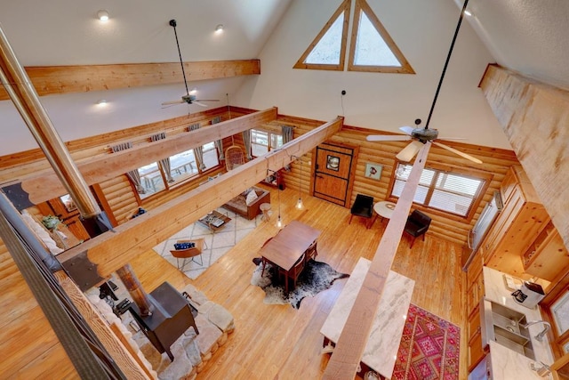 4255 Fm 3405, Georgetown, TX 78633 - living room with high vaulted ceiling, a ceiling fan, rustic walls, wood finished floors, and beam ceiling